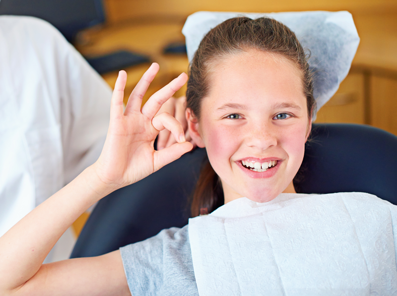 girl-smiles-at-dentist-showing-ok-sign-2026-01-09-10-24-36-utc